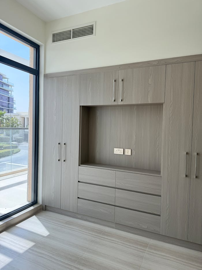 Elegant minimalist wardrobe design in a bright modern interior.